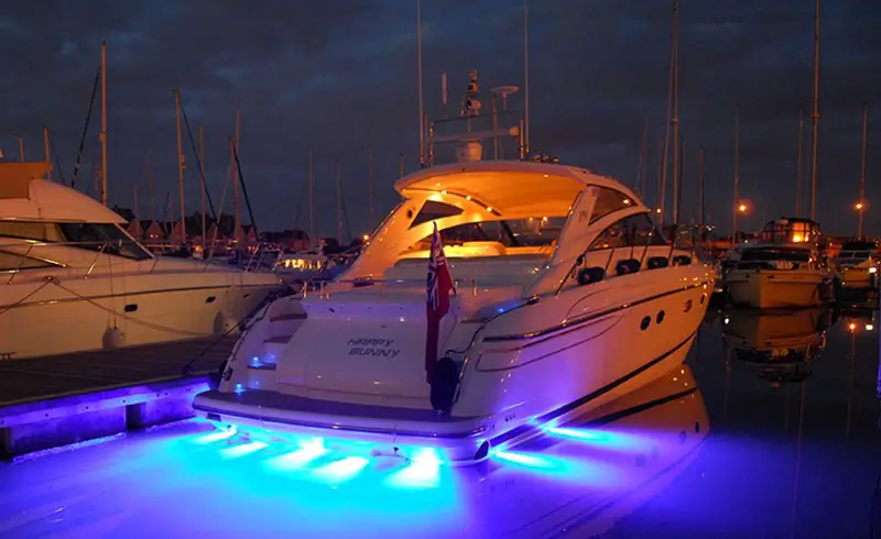 Bluefin lights glowing behind powerboat in marina Bluefin lights glowing behind powerboat in marina